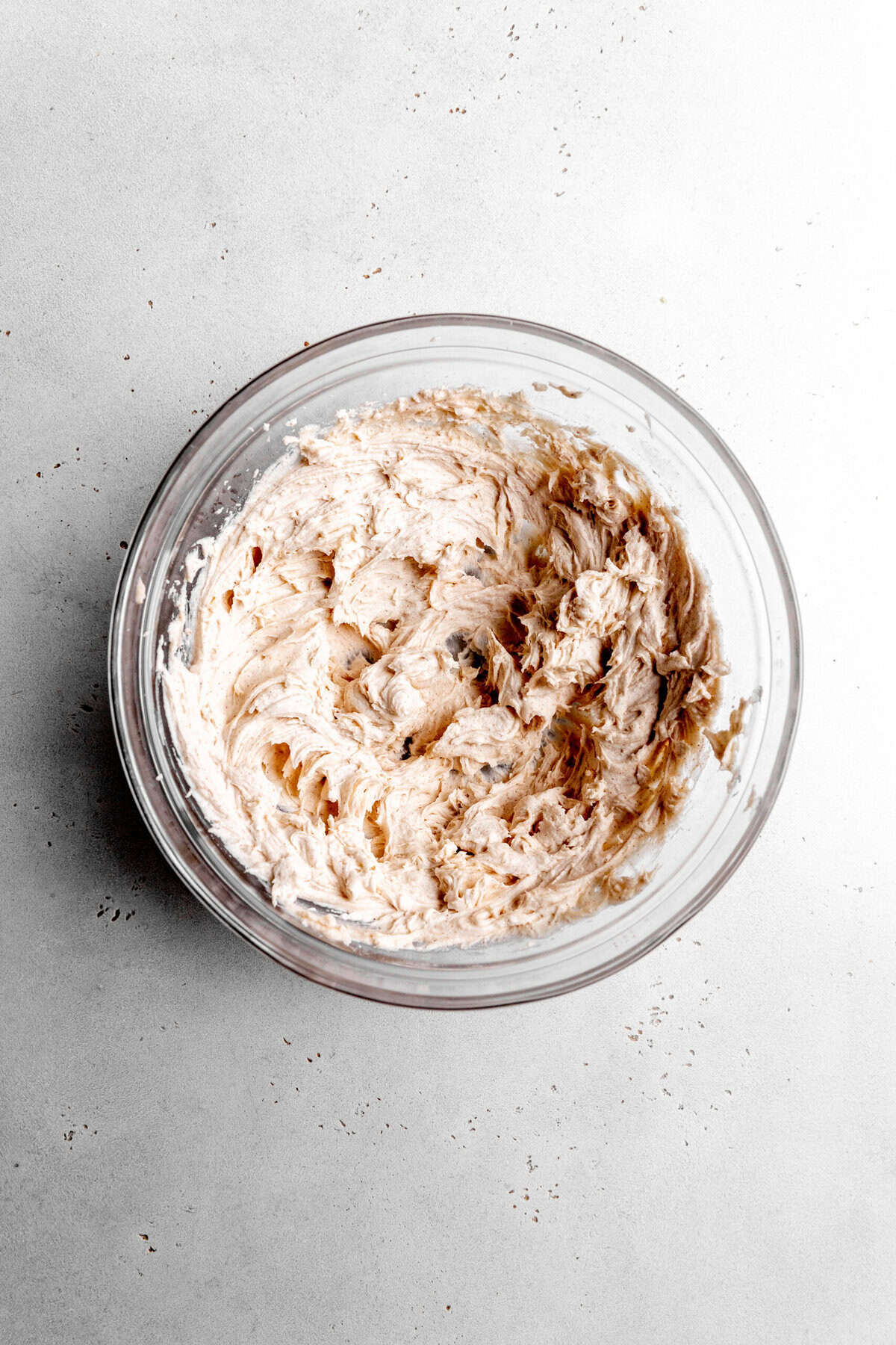 Glass bowl of cinnamon sugar frosting.