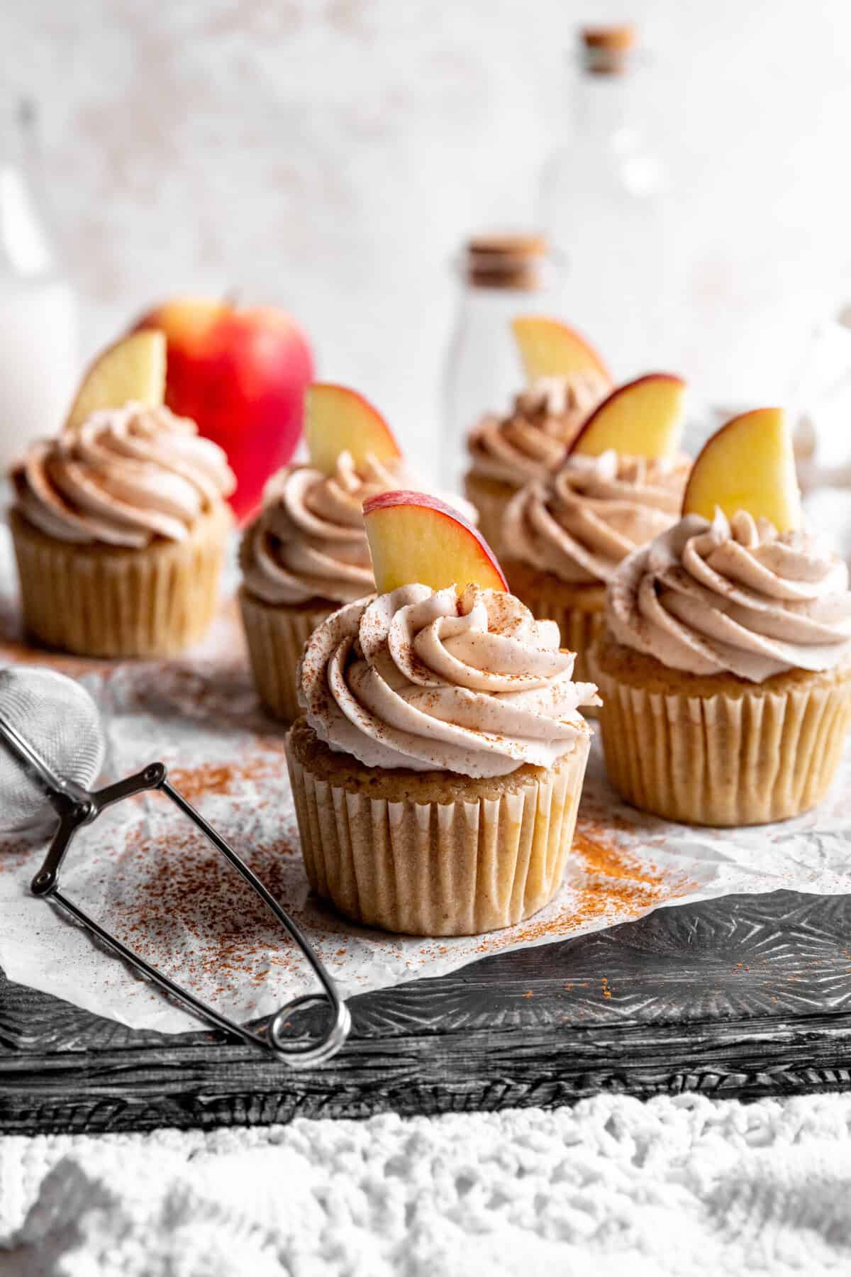 Apple cinnamon cupcakes topped with fresh apple slices.
