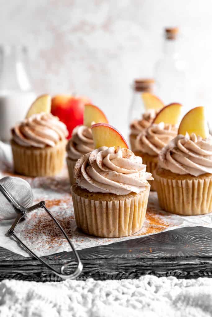 Apple cinnamon cupcakes and a jug of milk.