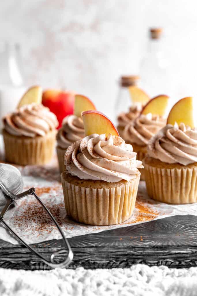 Apple cinnamon cupcakes and a jug of milk.