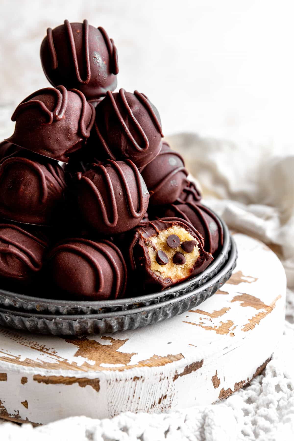 Stack of cookie dough bites and a white linen napkin.