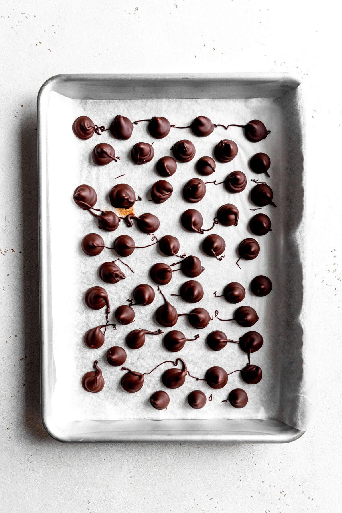 Set vegan Hershey Kisses on a baking sheet.