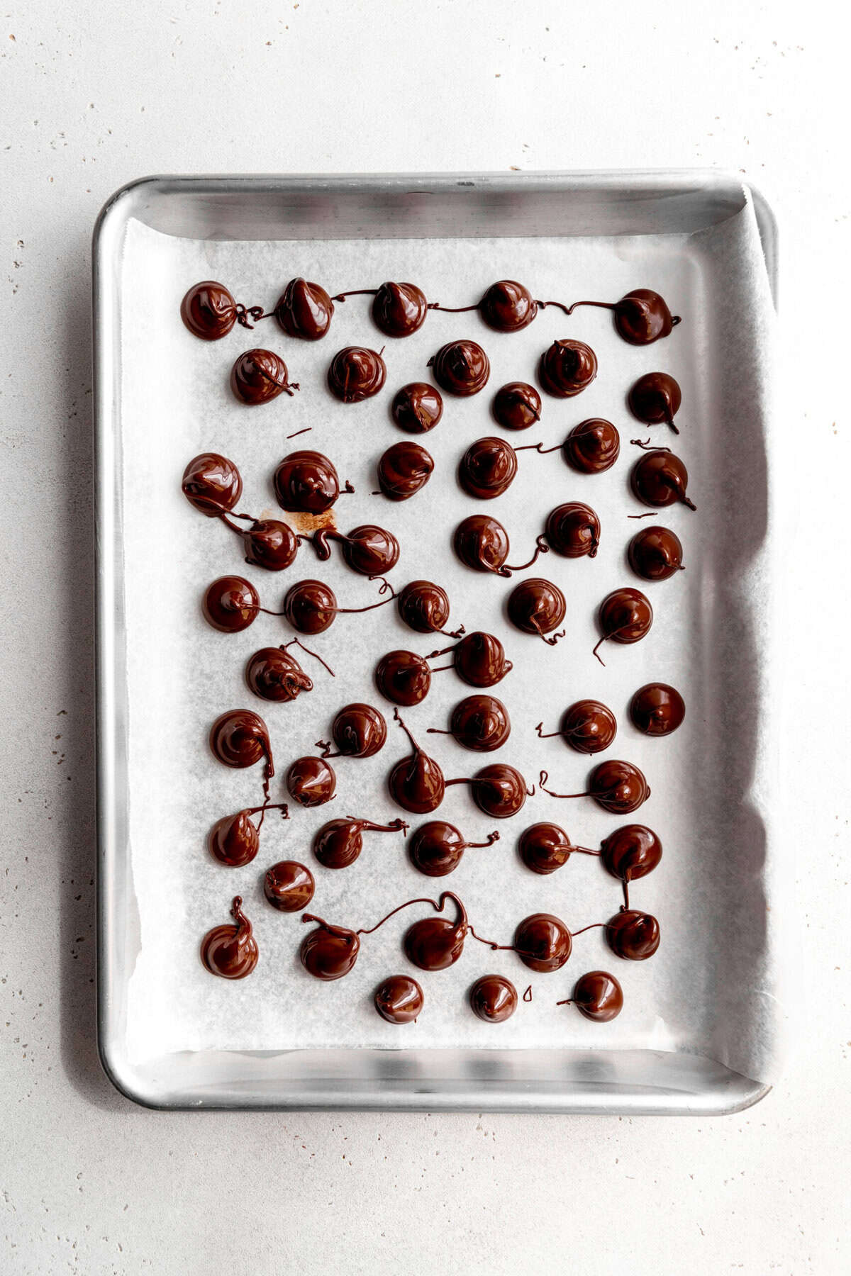 Unset vegan Hershey Kisses on a baking sheet.