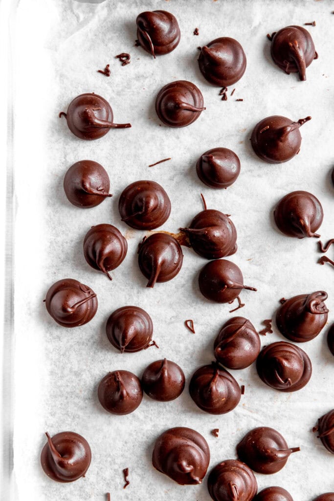 Piped Hershey Kisses on a baking sheet.