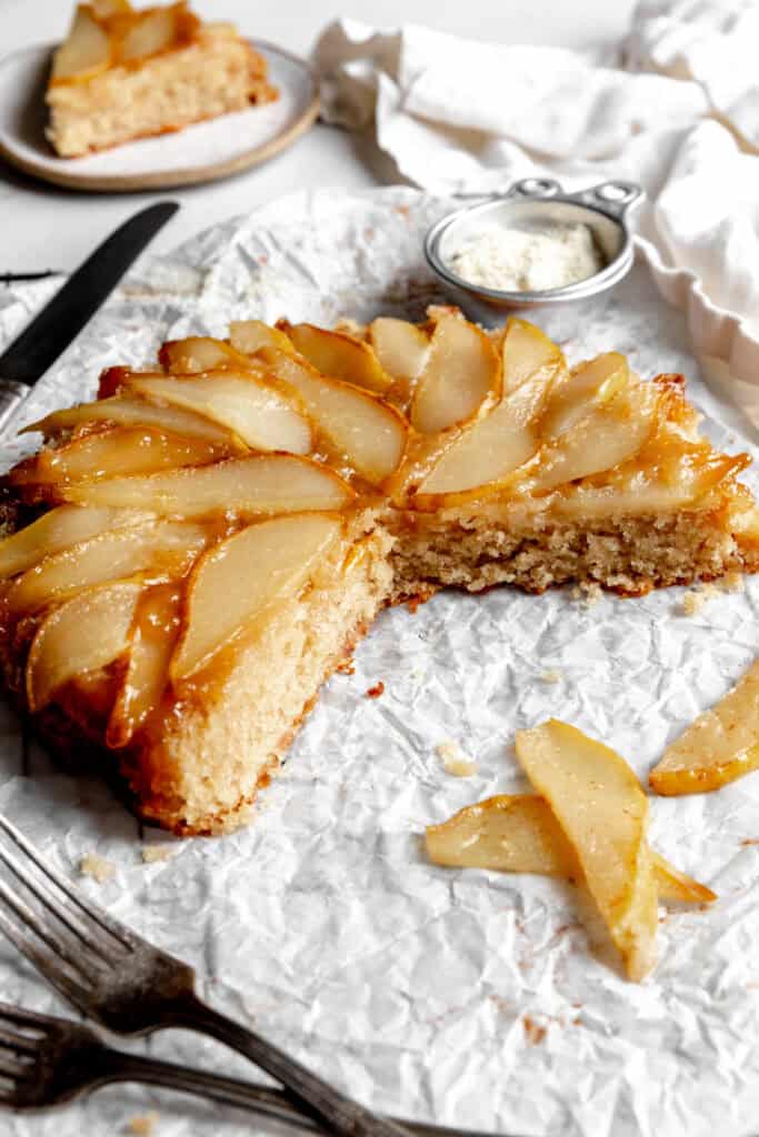 Pear upside down cake with slices missing.