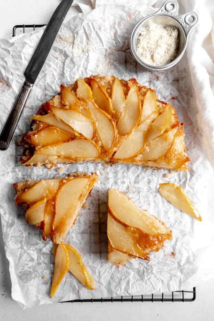 Slices being pulled out of a pear upside down cake.