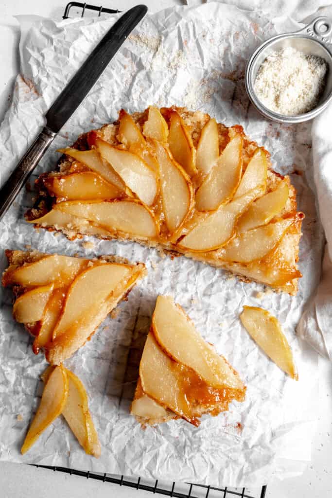 Slices being pulled out of a pear upside down cake.