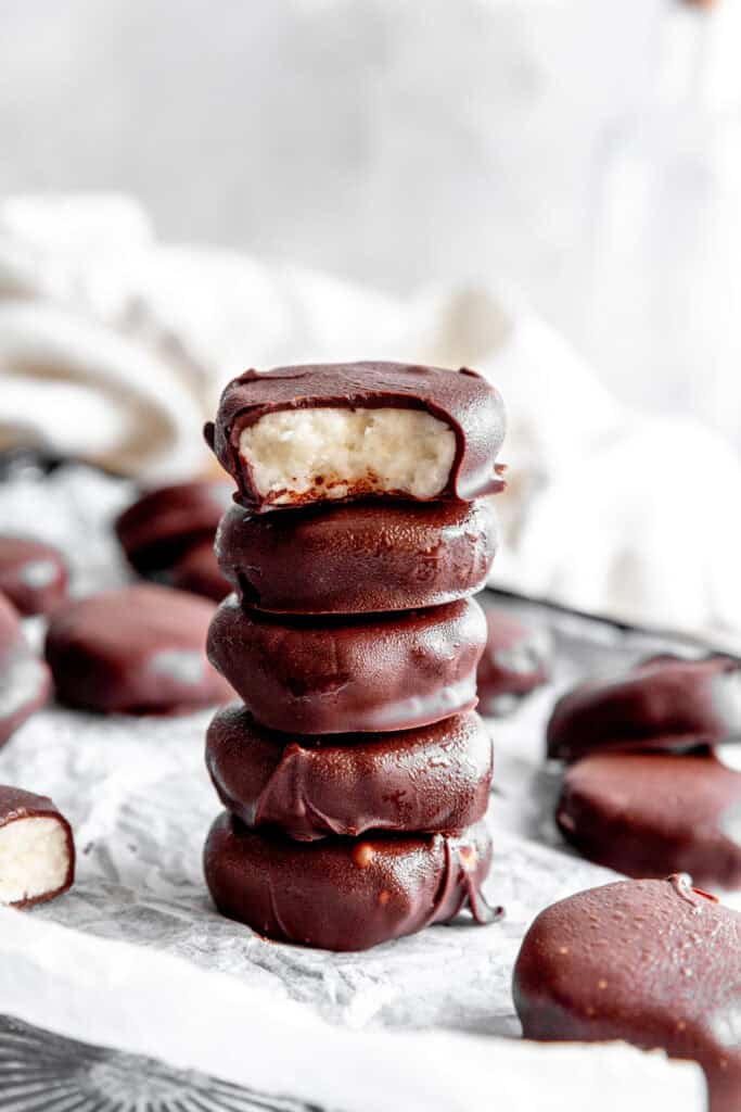 Stack of peppermint patties on a baking sheet and a linen napkin.