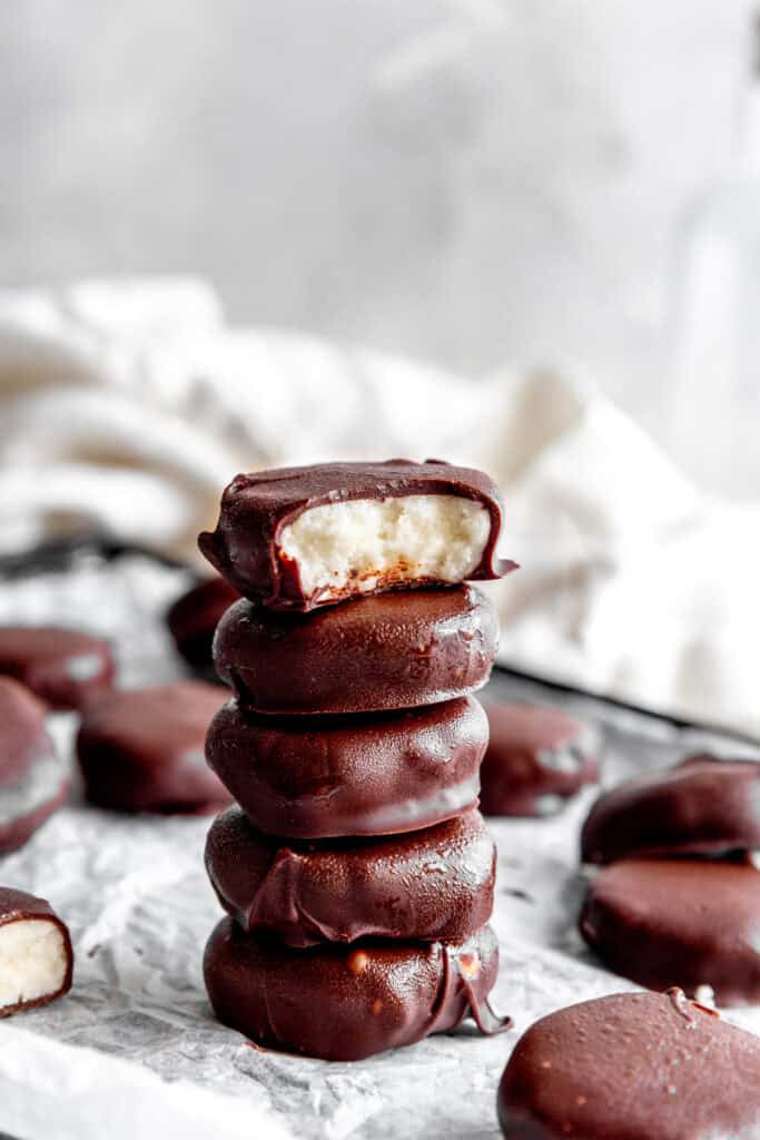 Stack of peppermint patties on a baking sheet and a linen napkin.