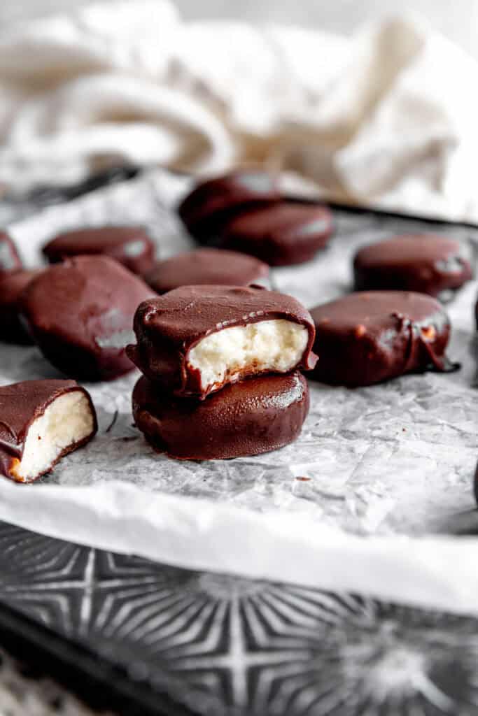 Peppermint patty with a bite taken out of it on top of another patty.