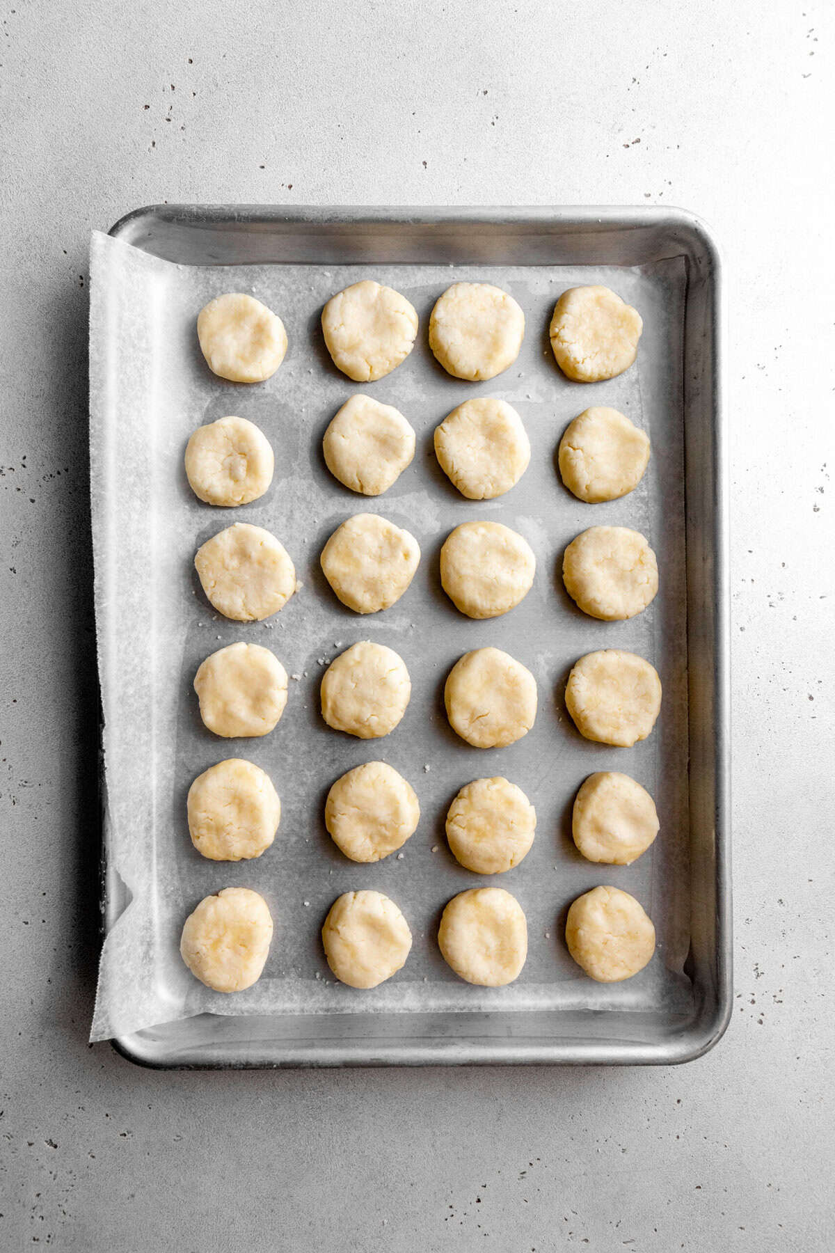 Uncoated peppermint patties on a baking sheet.