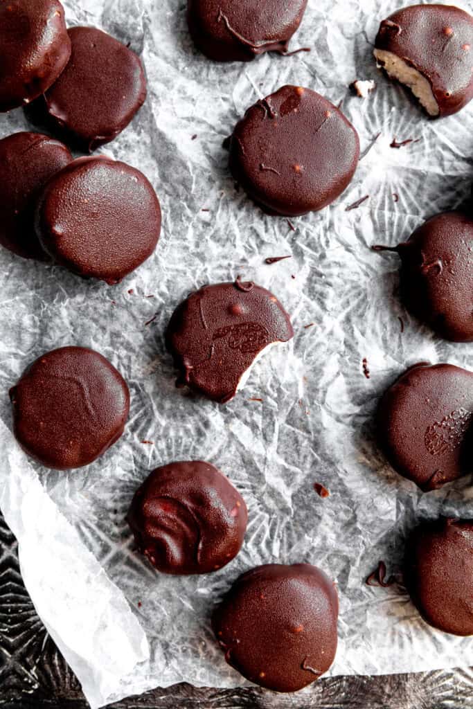 Peppermint patties on a baking sheet lined with wax paper.