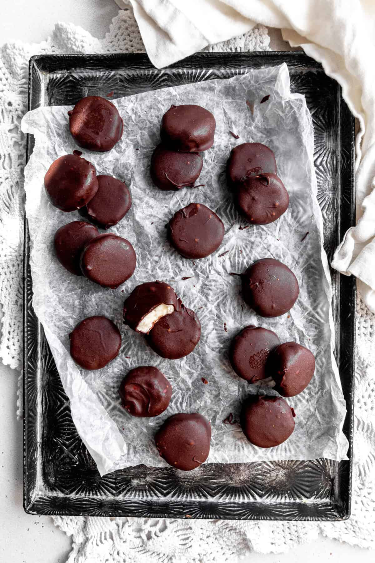 Peppermint patties on a baking sheet and a white linen napkin.