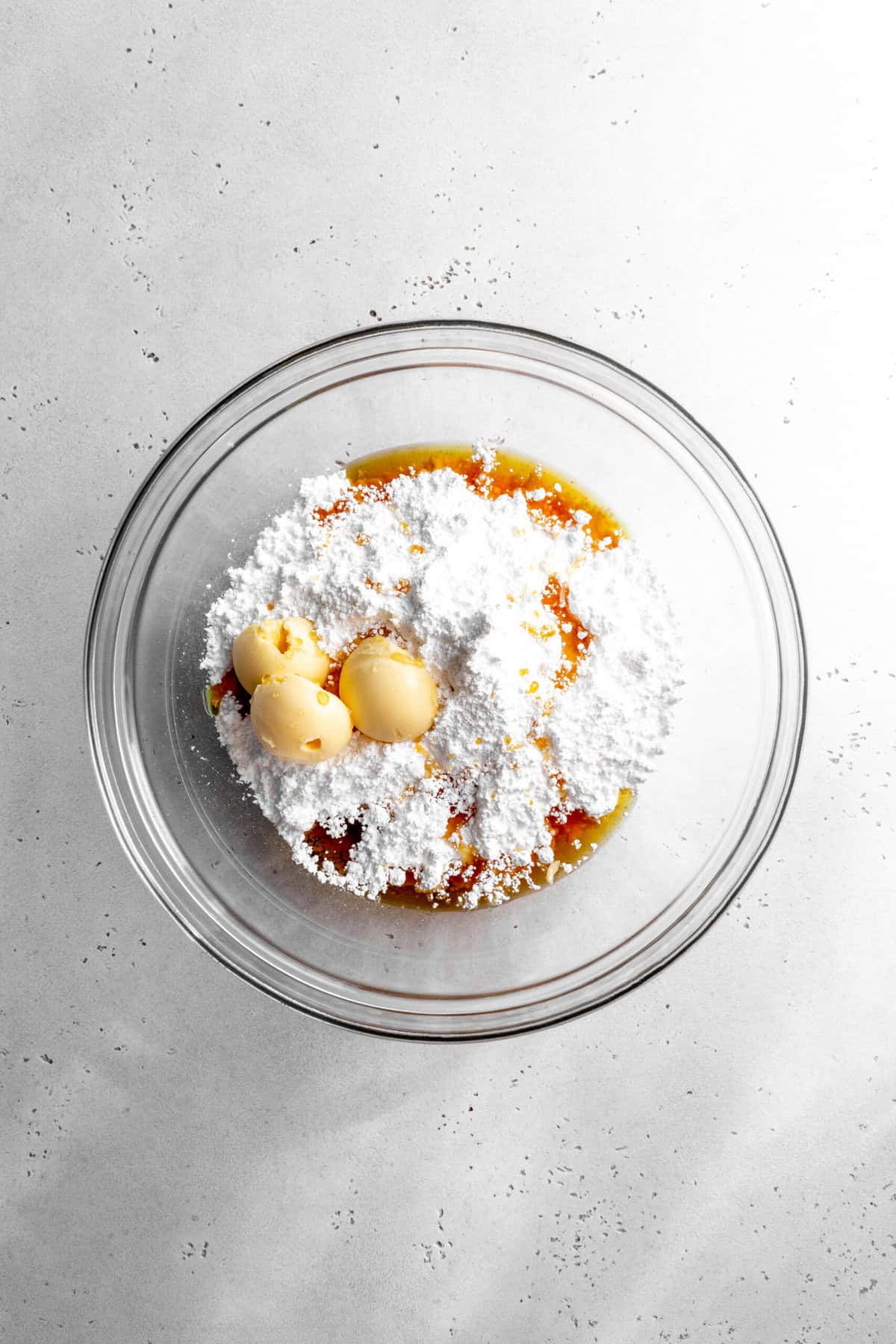 Glass bowl filled with powdered sugar, agave nectar and butter.