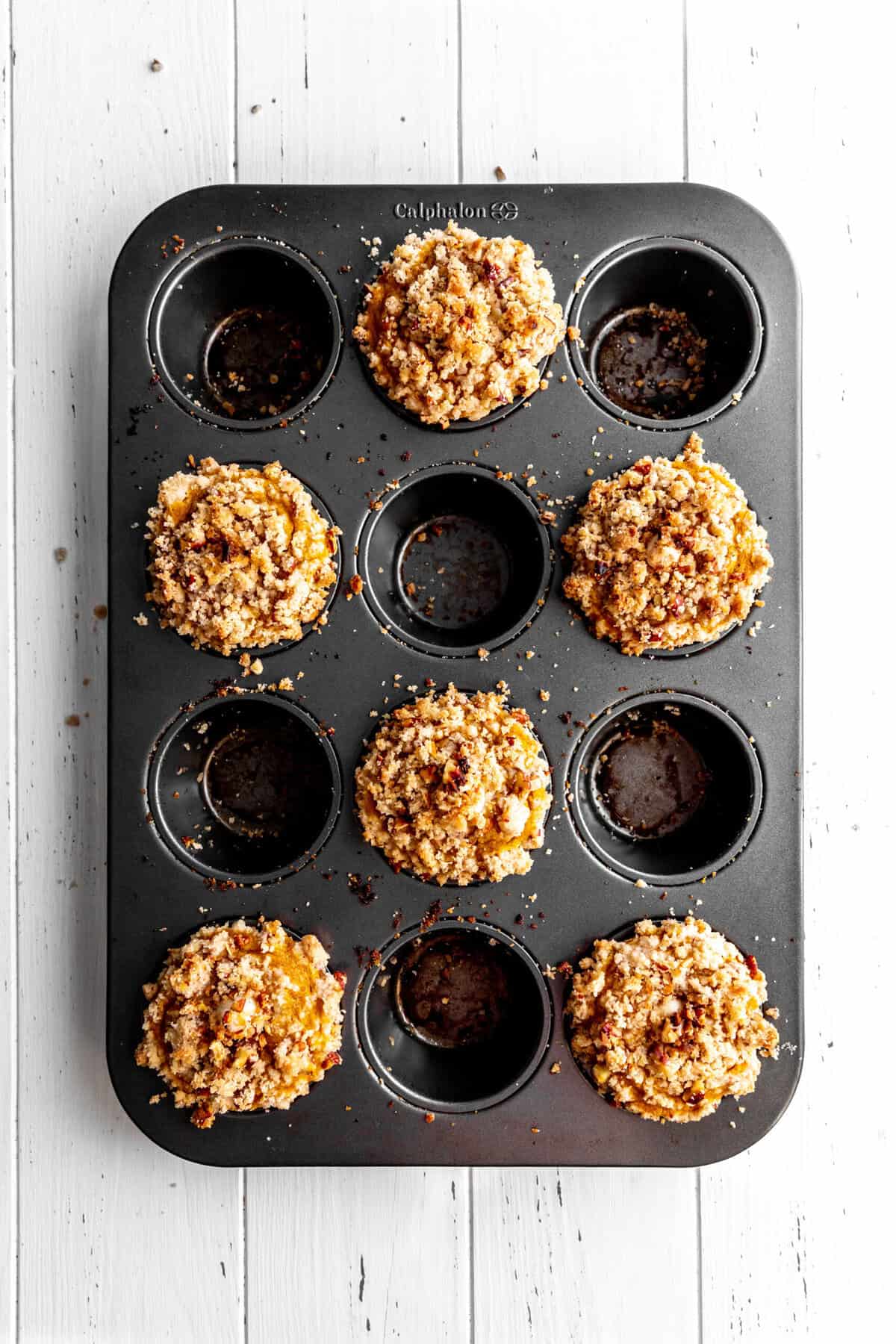 Baked pumpkin muffins in a cupcake pan.