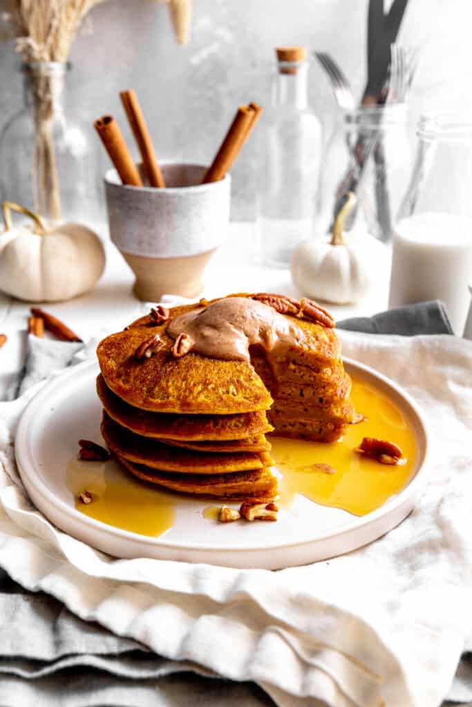 Stack of pumpkin pancakes with a triangle cut out.