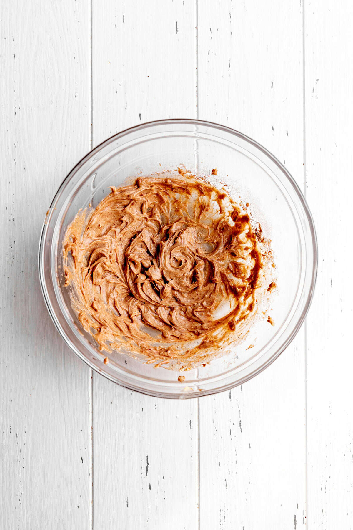 Whipped vegan butter and cinnamon in a glass bowl.