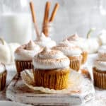 Wrapper peeling off a pumpkin pie cupcake.