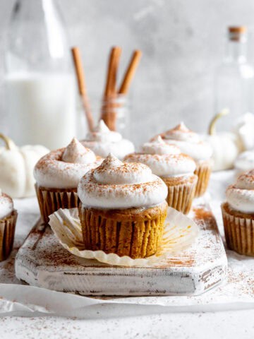Wrapper peeling off a pumpkin pie cupcake.
