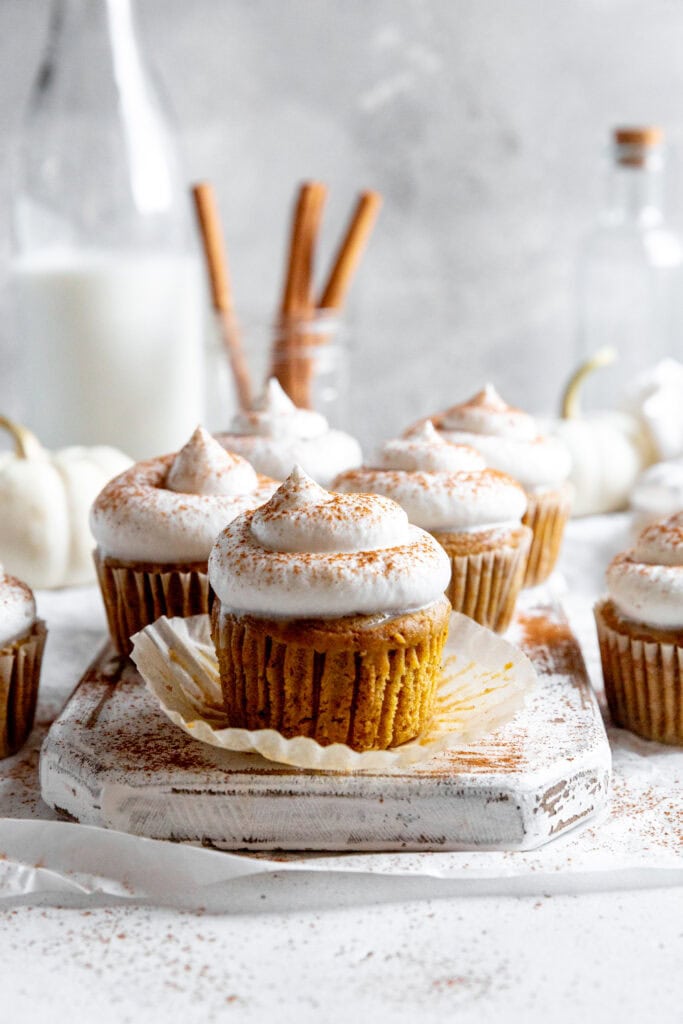 Wrapper peeling off a pumpkin pie cupcake.
