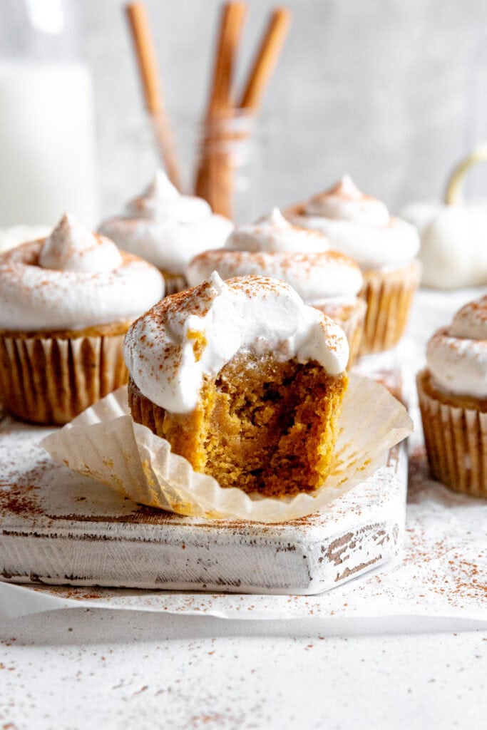 Pumpkin cupcake with a bite taken out of it.