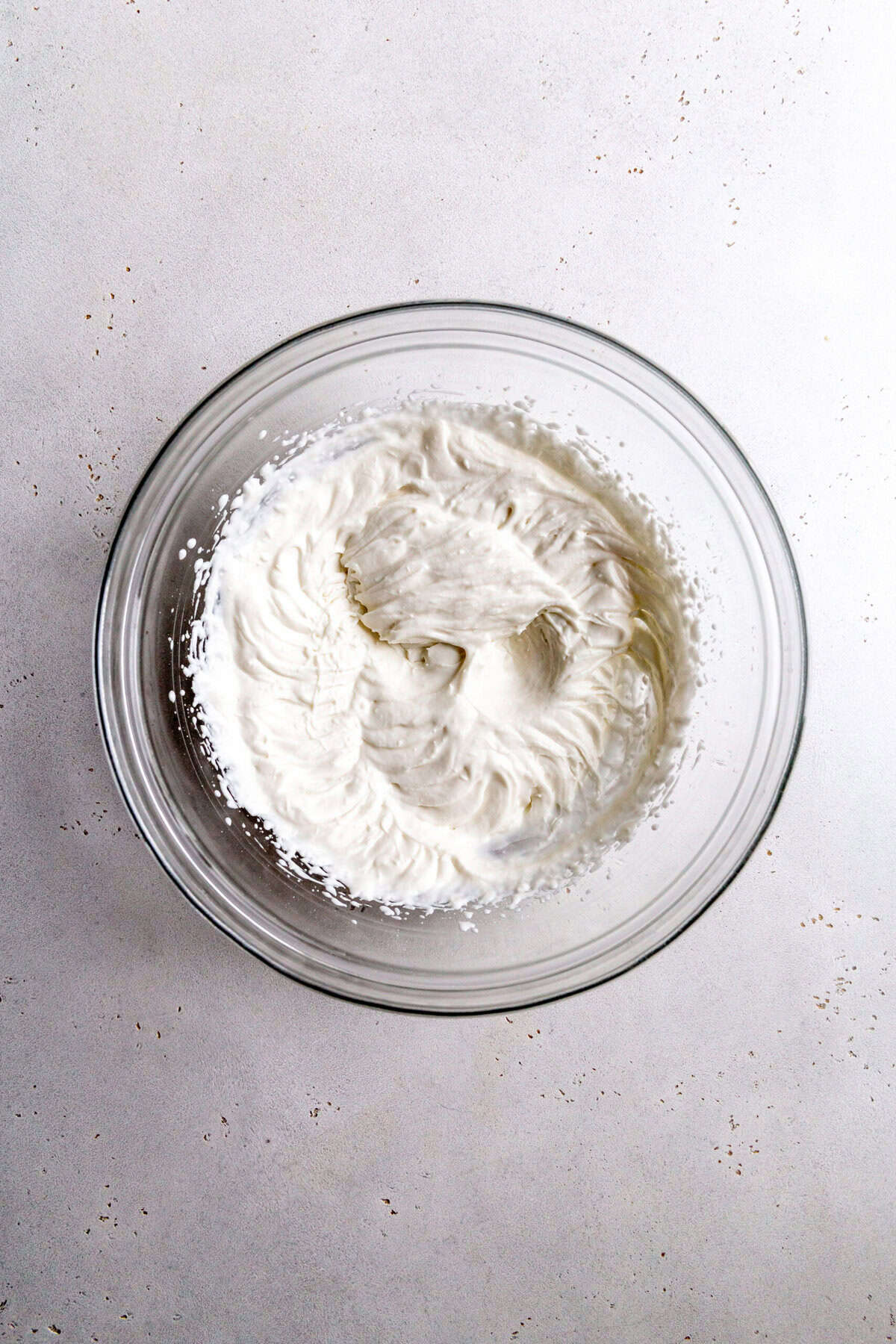Whipped cream in a glass bowl.