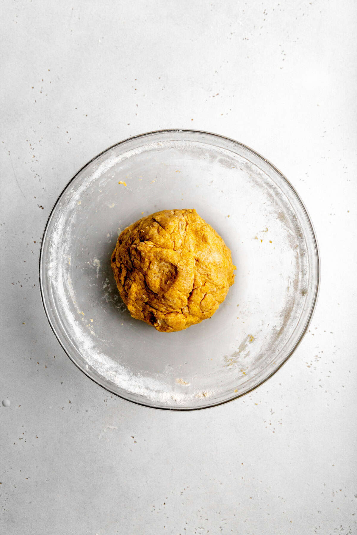 Pumpkin scone dough in a glass bowl.