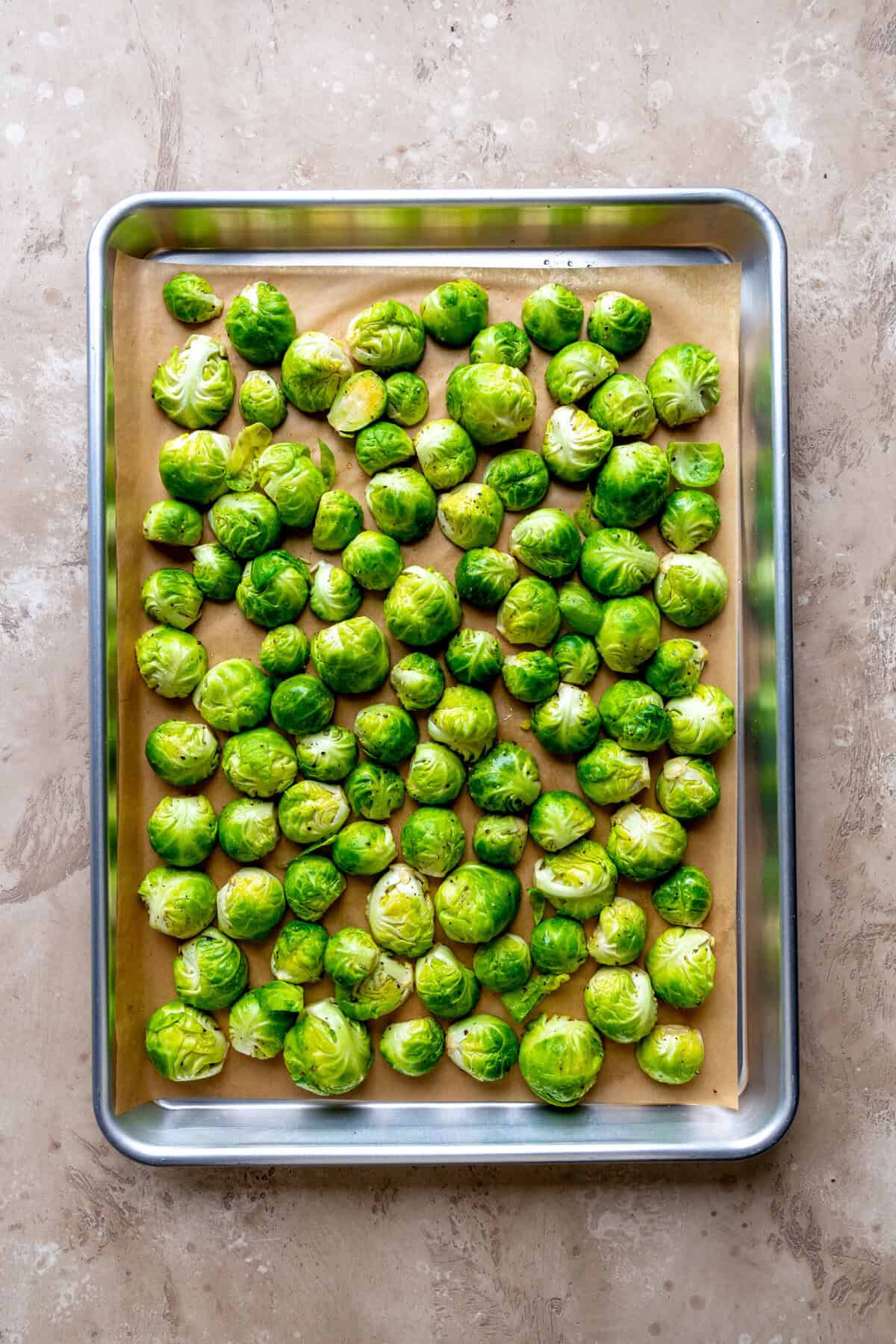 Brussels sprout halves on a baking sheet.