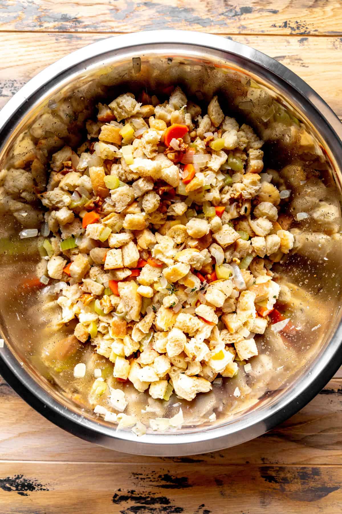 Large bowl of bread cubes and sautéed veggies.