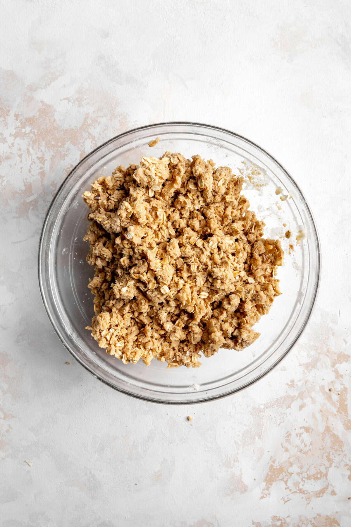 Glass bowl of oat crumble topping.