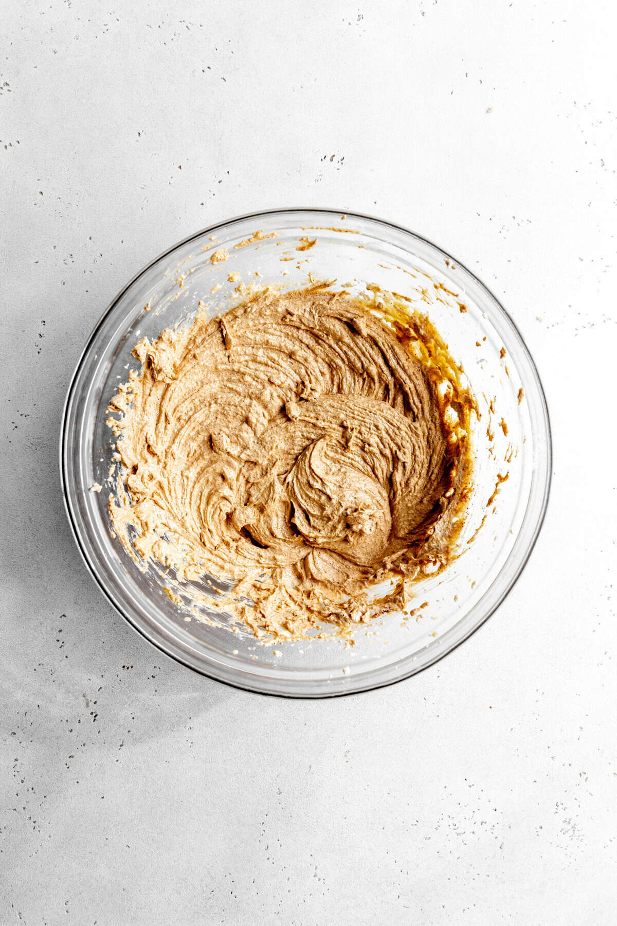 Glass bowl of creamed butter and sugar.