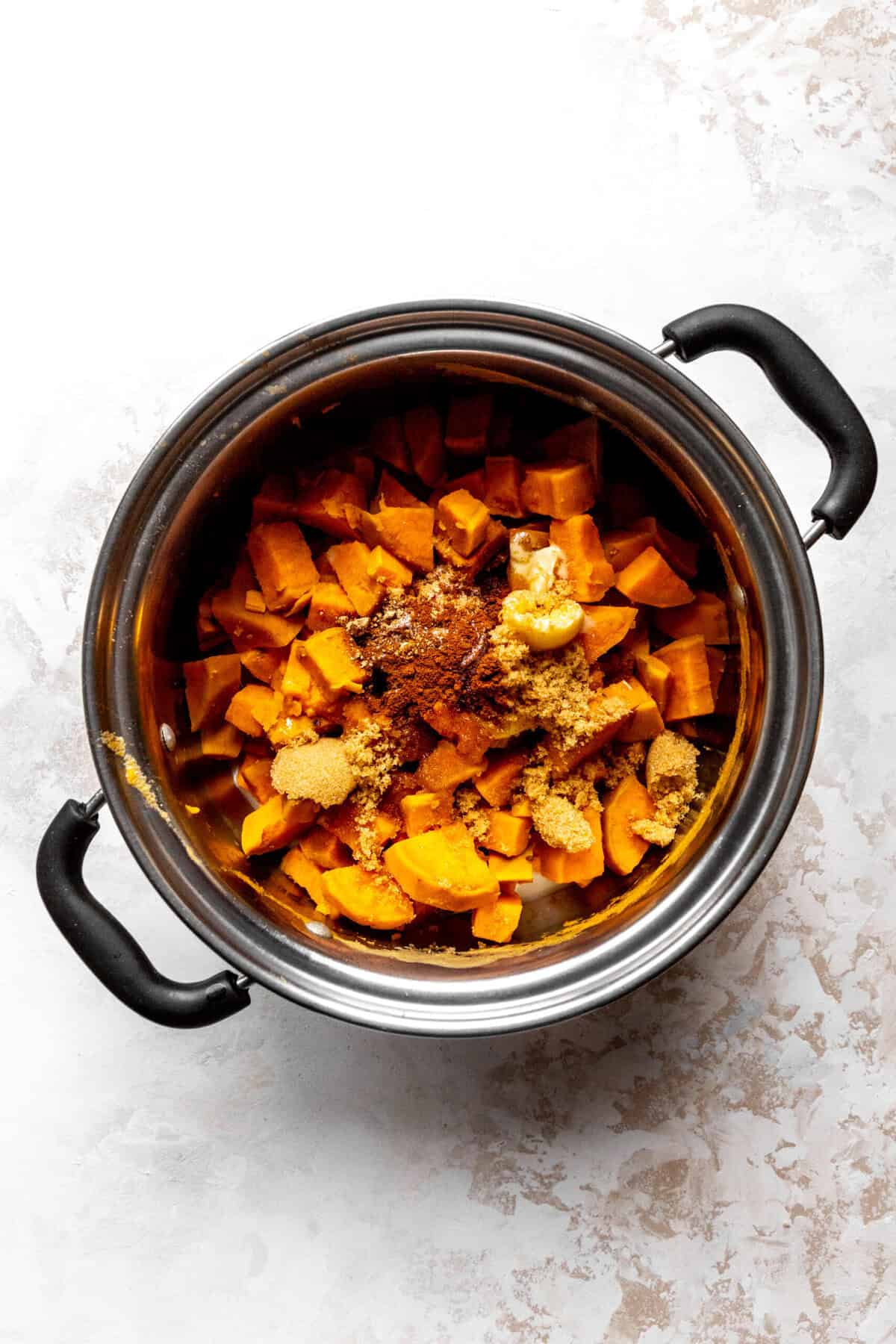 Pot of cubed sweet potatoes and spices.