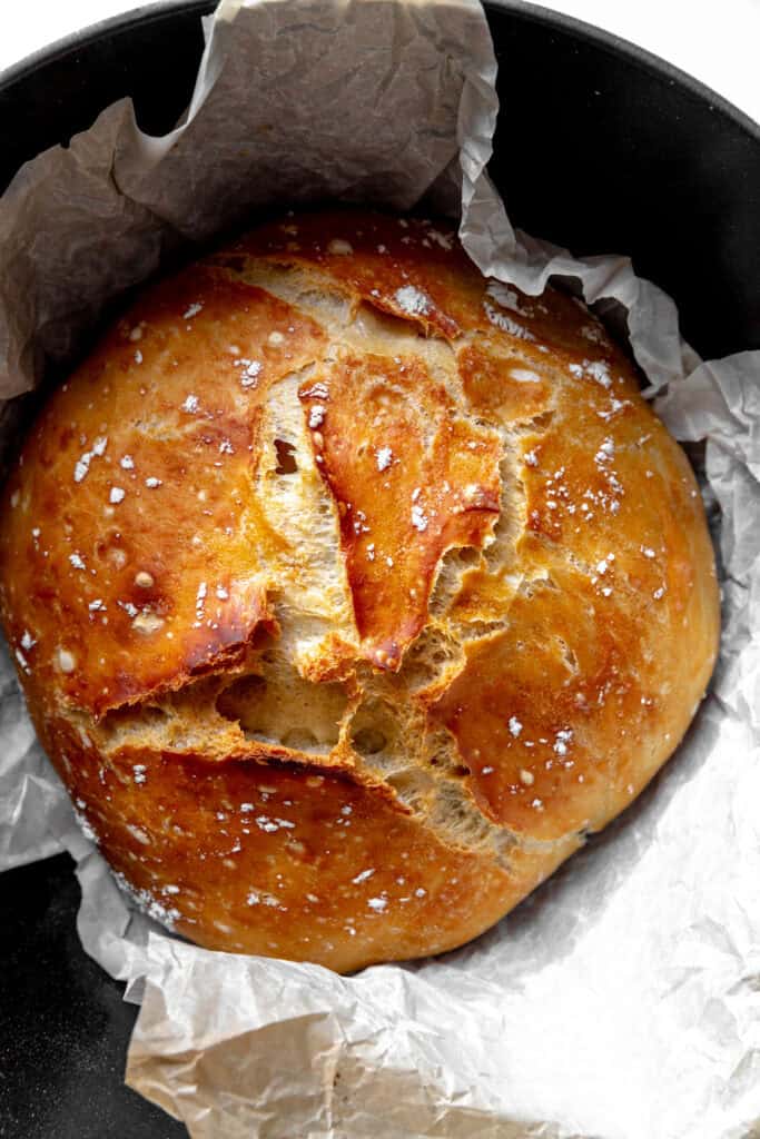 Round loaf of bread wrapped in parchment paper.