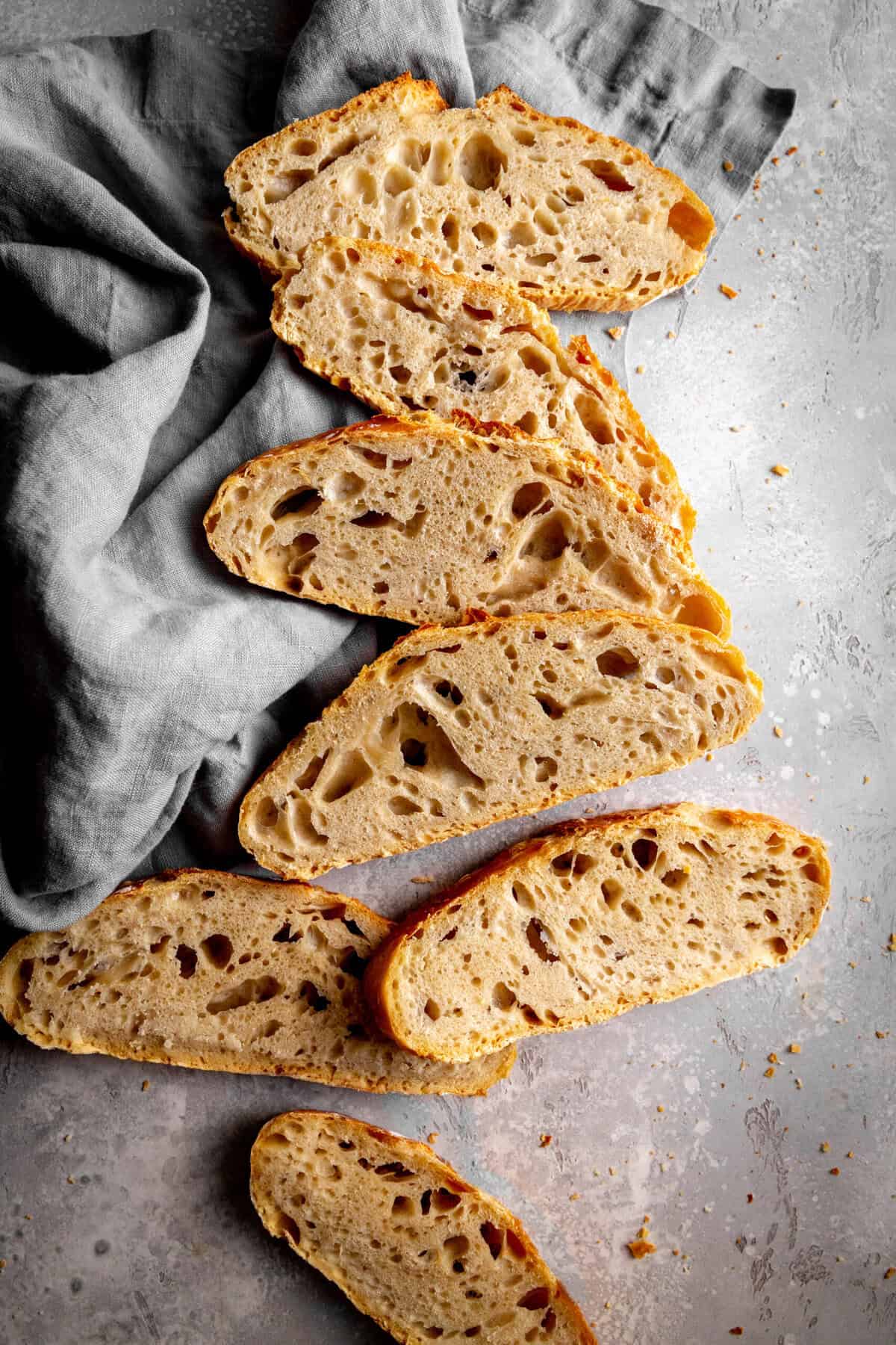 Slices of bread spread out on a linen napkin.