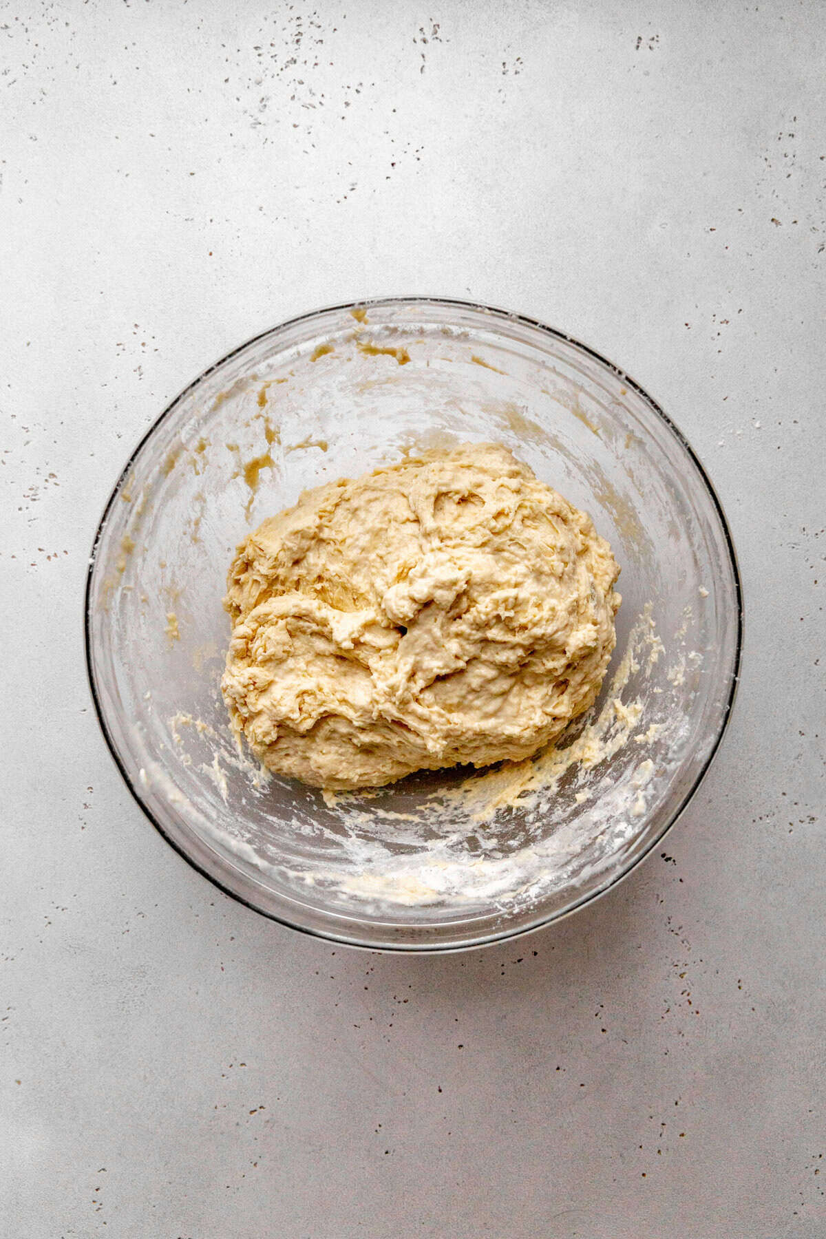 Bread dough in a glass bowl.