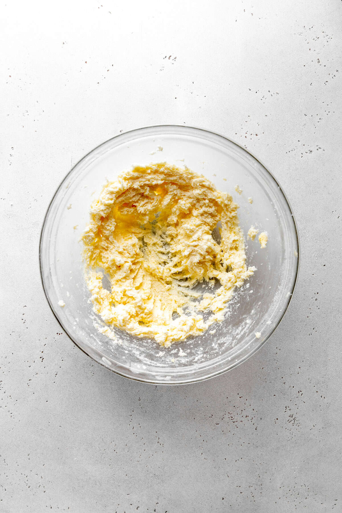 Creamed butter and sugar in a glass bowl.