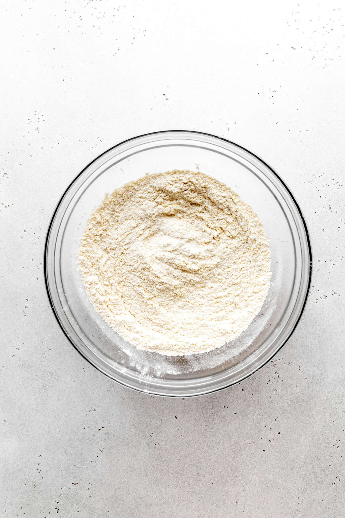 Glass bowl of flour and sugar.