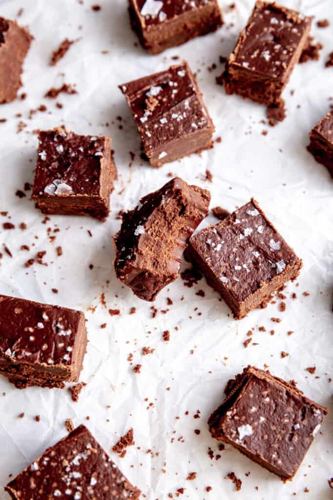 Piece of fudge with a bite taken out of it propped on another piece of fudge.