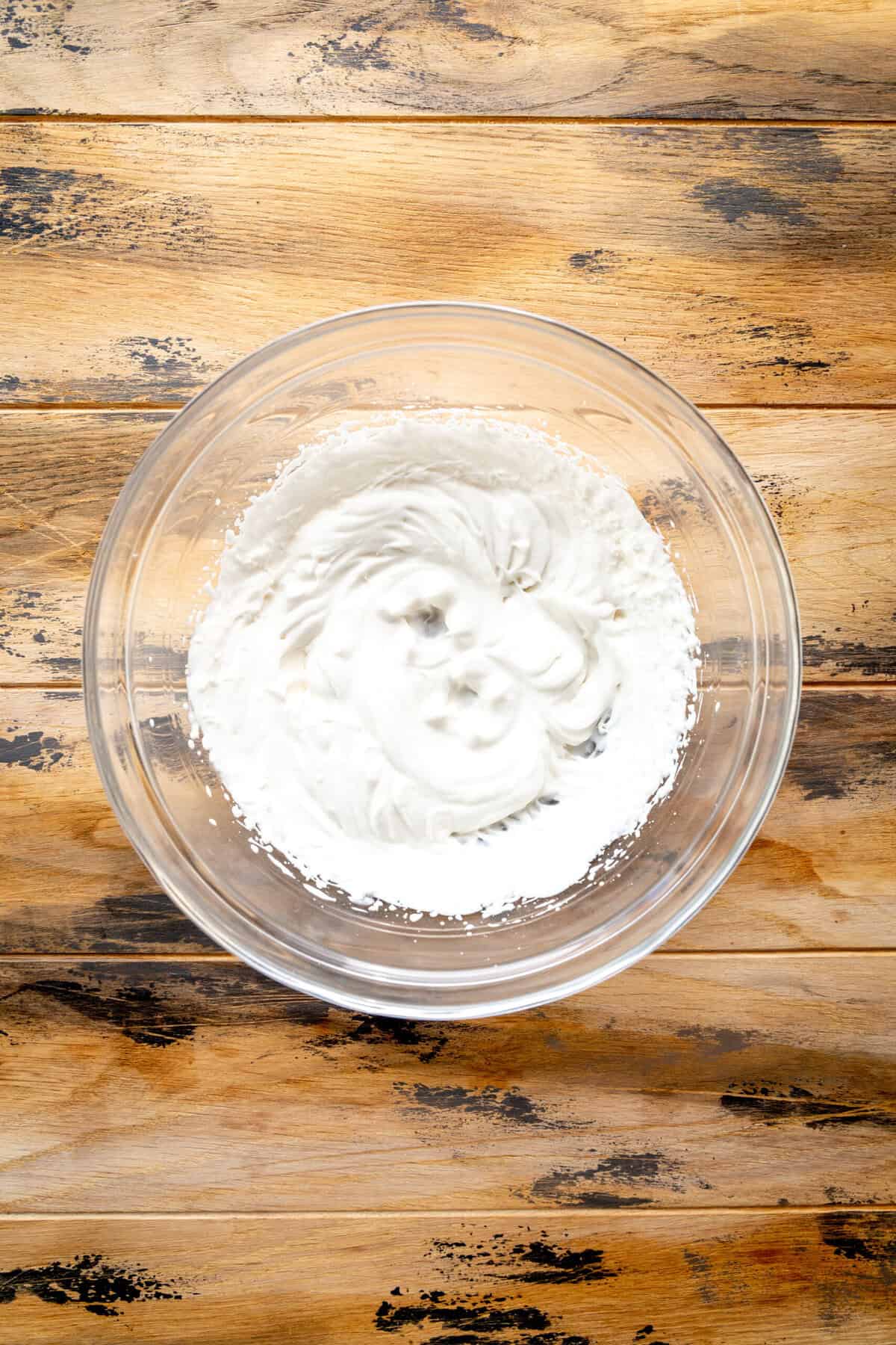 Whipped cream in a glass bowl.