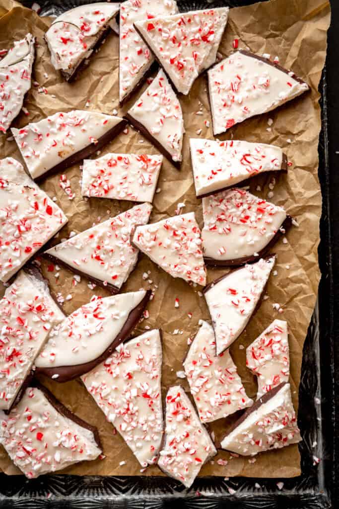 Chunks of peppermint bark broken up on a baking sheet.