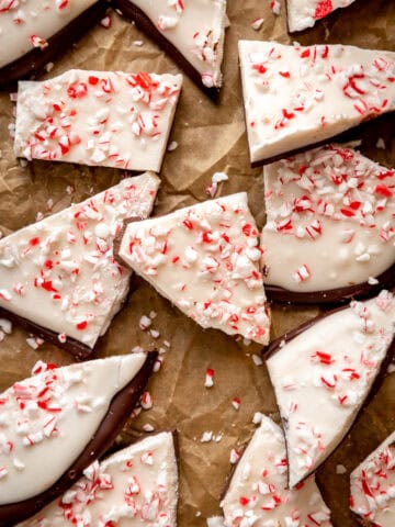 Chunks of peppermint bark laid out on brown parchment paper.