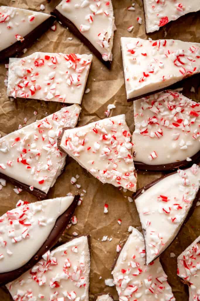 Chunks of peppermint bark laid out on brown parchment paper.