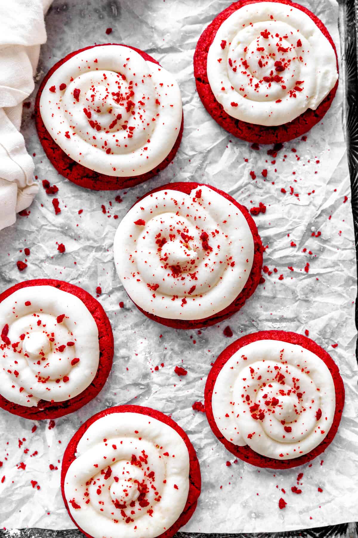 Red velvet cake cookies on a baking sheet and a linen napkin.