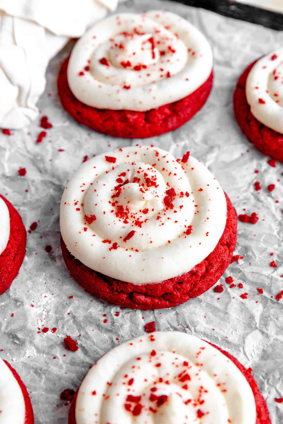 Red velvet cake cookies on a baking sheet and a linen napkin.