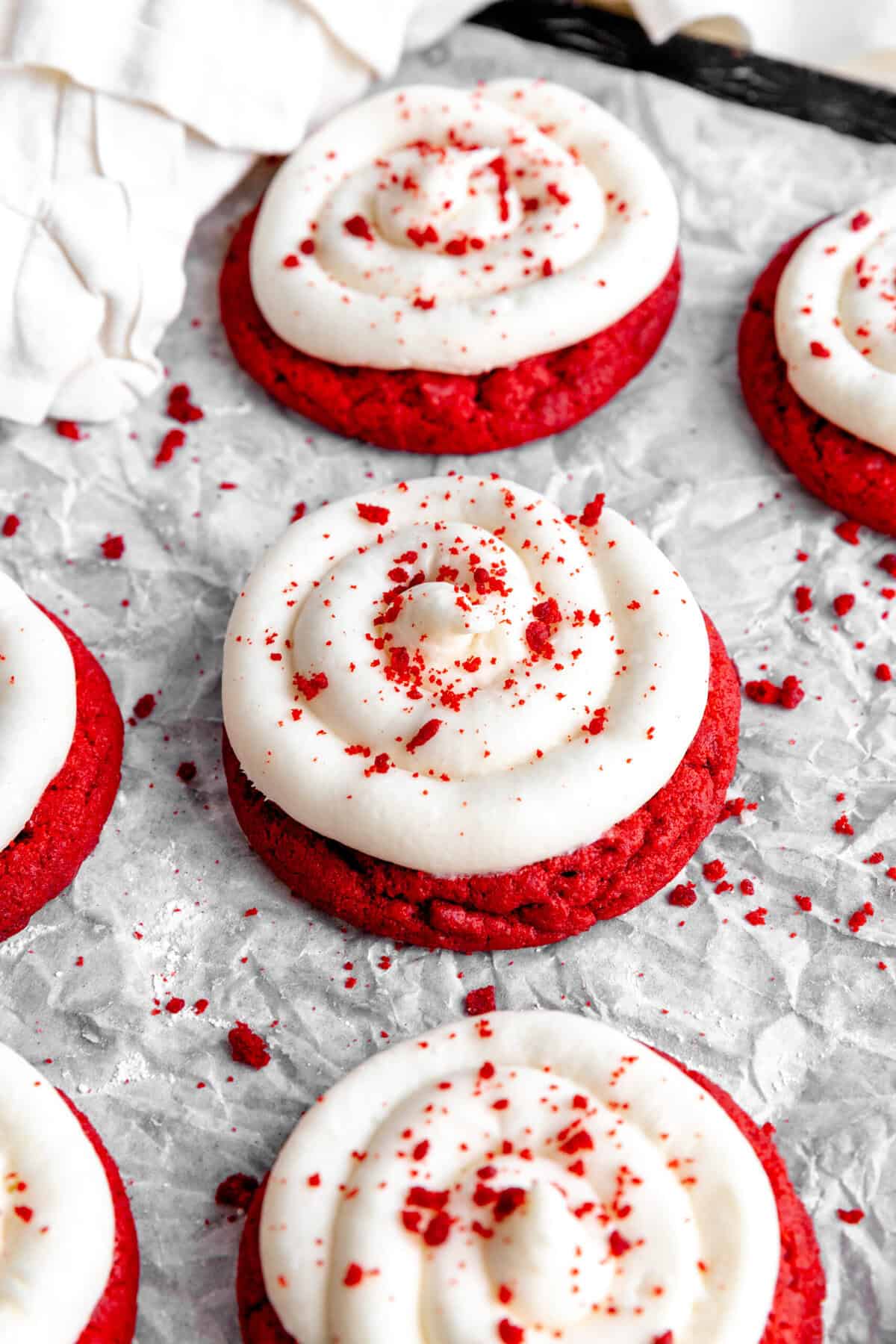 Red velvet cake cookies on a baking sheet and a linen napkin.