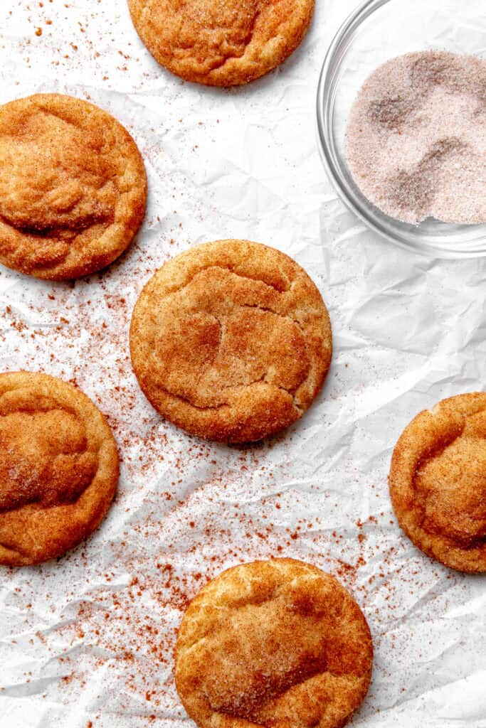 Vegan snickerdoodles and a bowl of cinnamon and sugar.