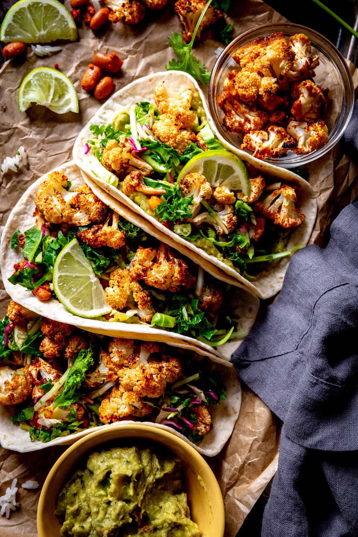 Three cauliflower tacos and a linen napkin.