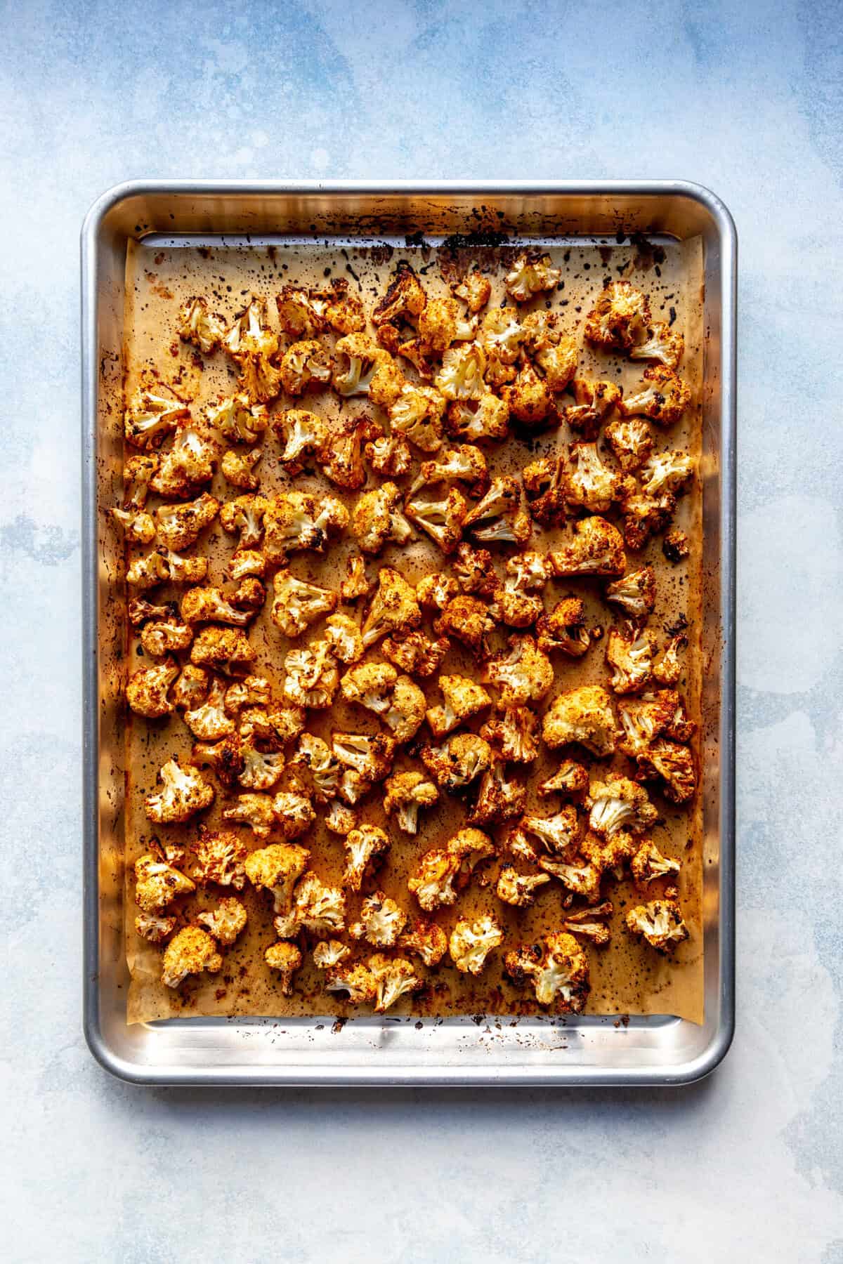 Roasted cauliflower on a baking sheet.