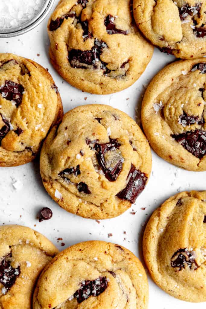 Vegan chocolate chip cookies on a white surface.