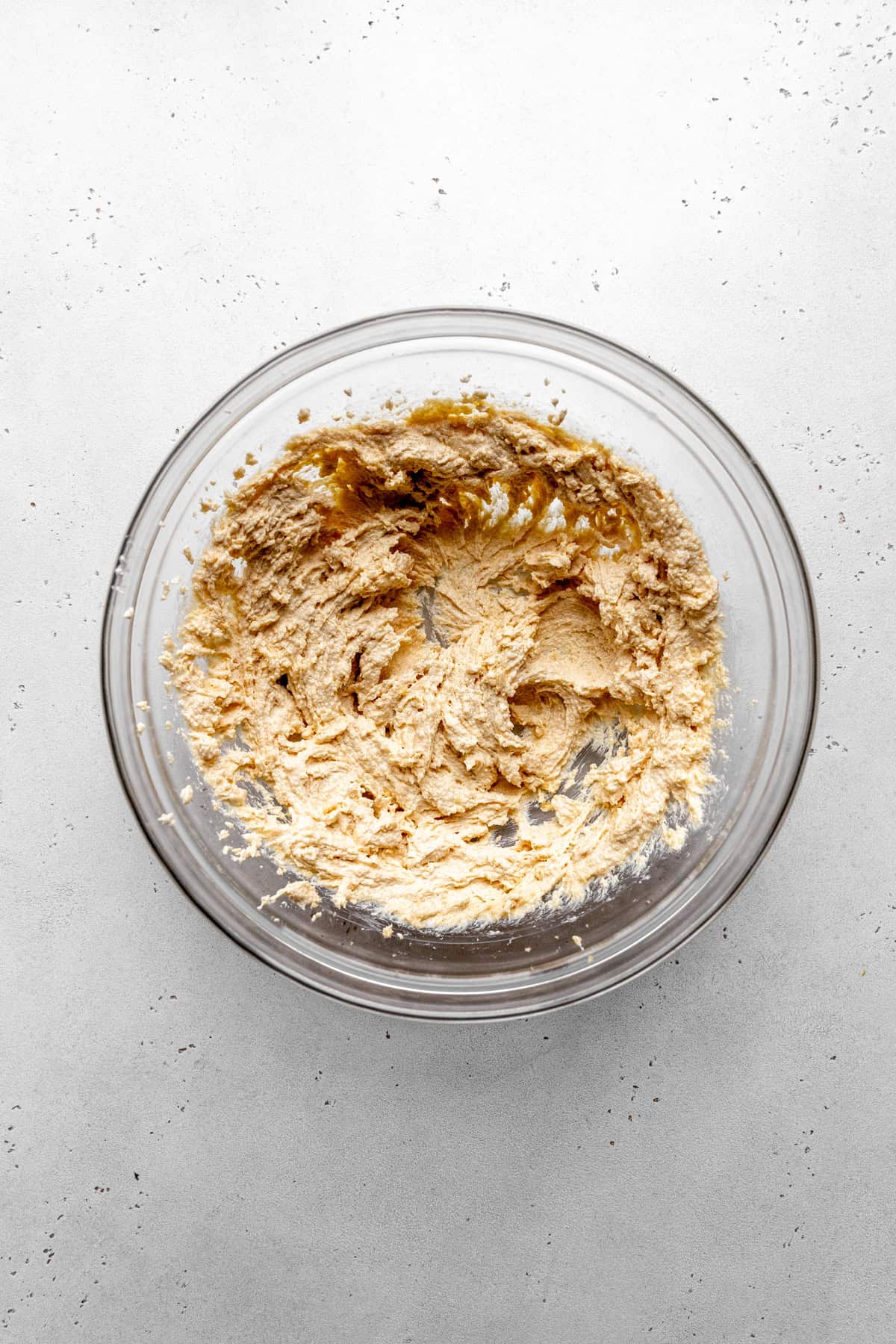 Glass bowl of creamed vegan butter and sugar.